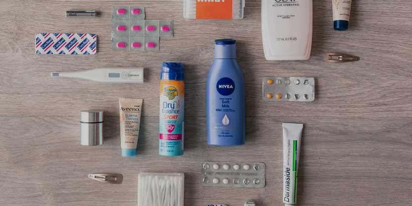 Travel medical kit with mosquito repellent, pills, thermometer, and personal care essentials for jungle and island trips