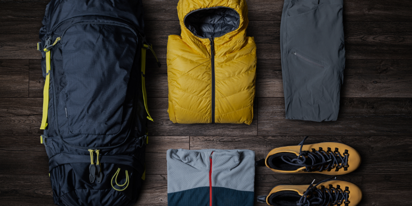 Hiking gear set with backpack, waterproof jacket, and boots for Borneo jungle eco-tours