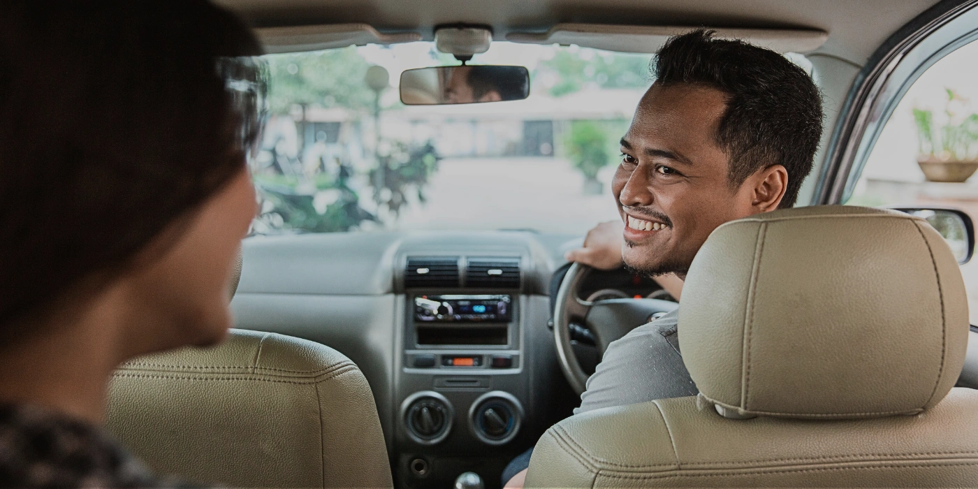 Person traveling in a private car through Sabah’s countryside on the way to Kinabatangan River