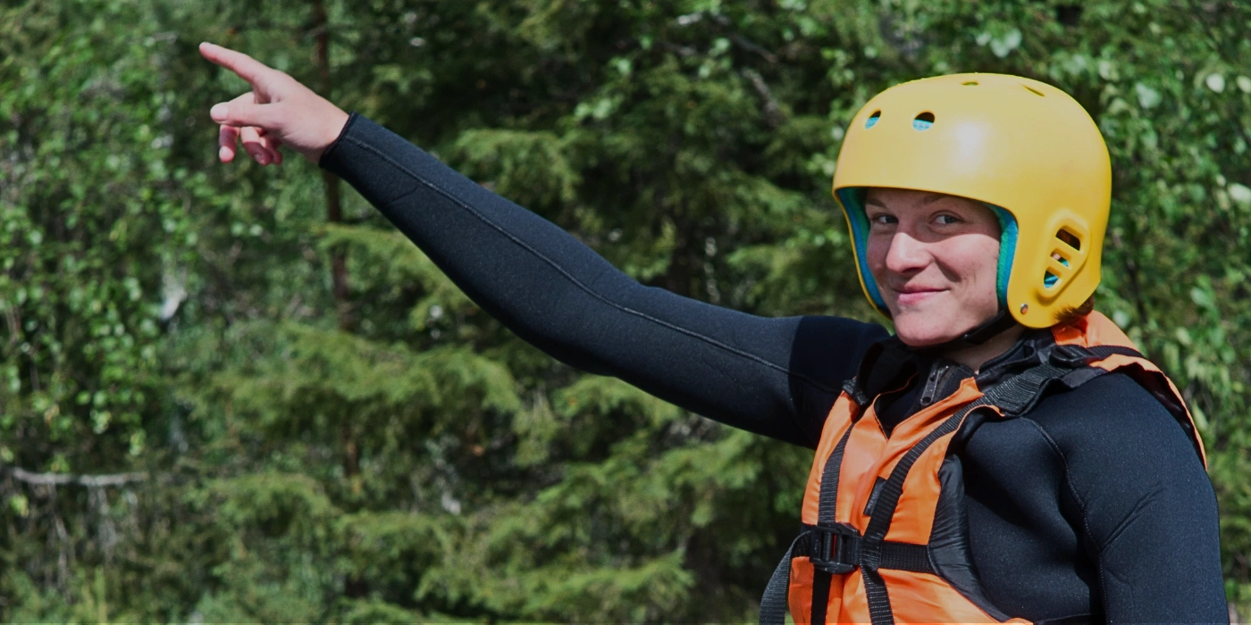 Woman wearing a helmet and life jacket, preparing for a rapid shooting boat ride in Taman Negara- - rapid shooting in taman negara