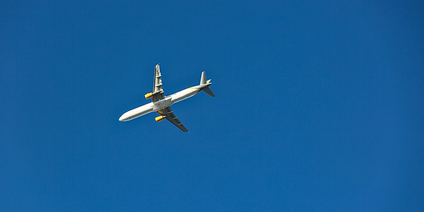 Airplane cruising through blue skies en route to Lahad Datu Airport, Sabah.