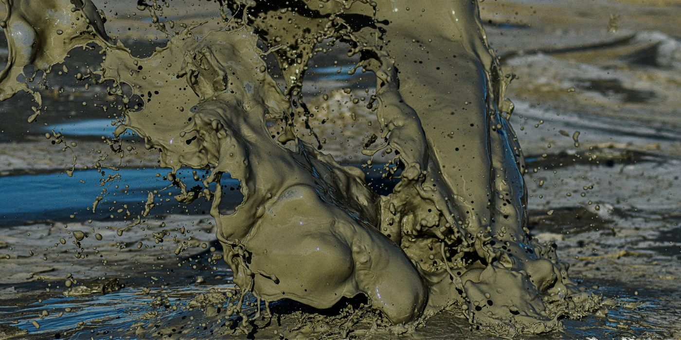 Powerful eruption of Tabin’s mud volcano with thick mud spewing high into the rainforest air