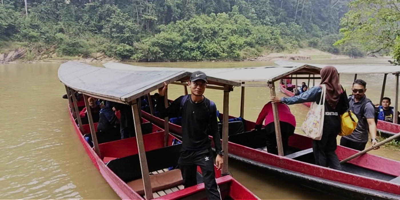 Two long boats departing on a thrilling rapid shooting journey through the river in Taman Negara rainforest