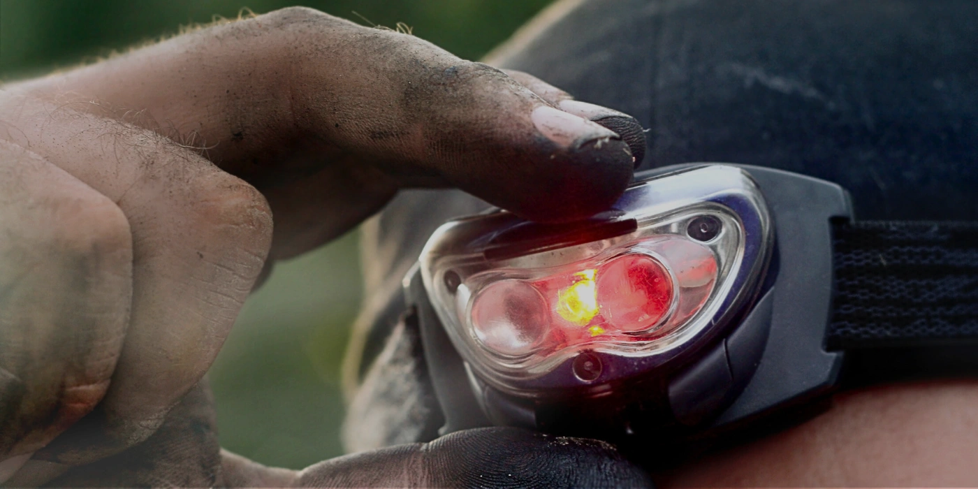 A man equipped with a compact headlamp