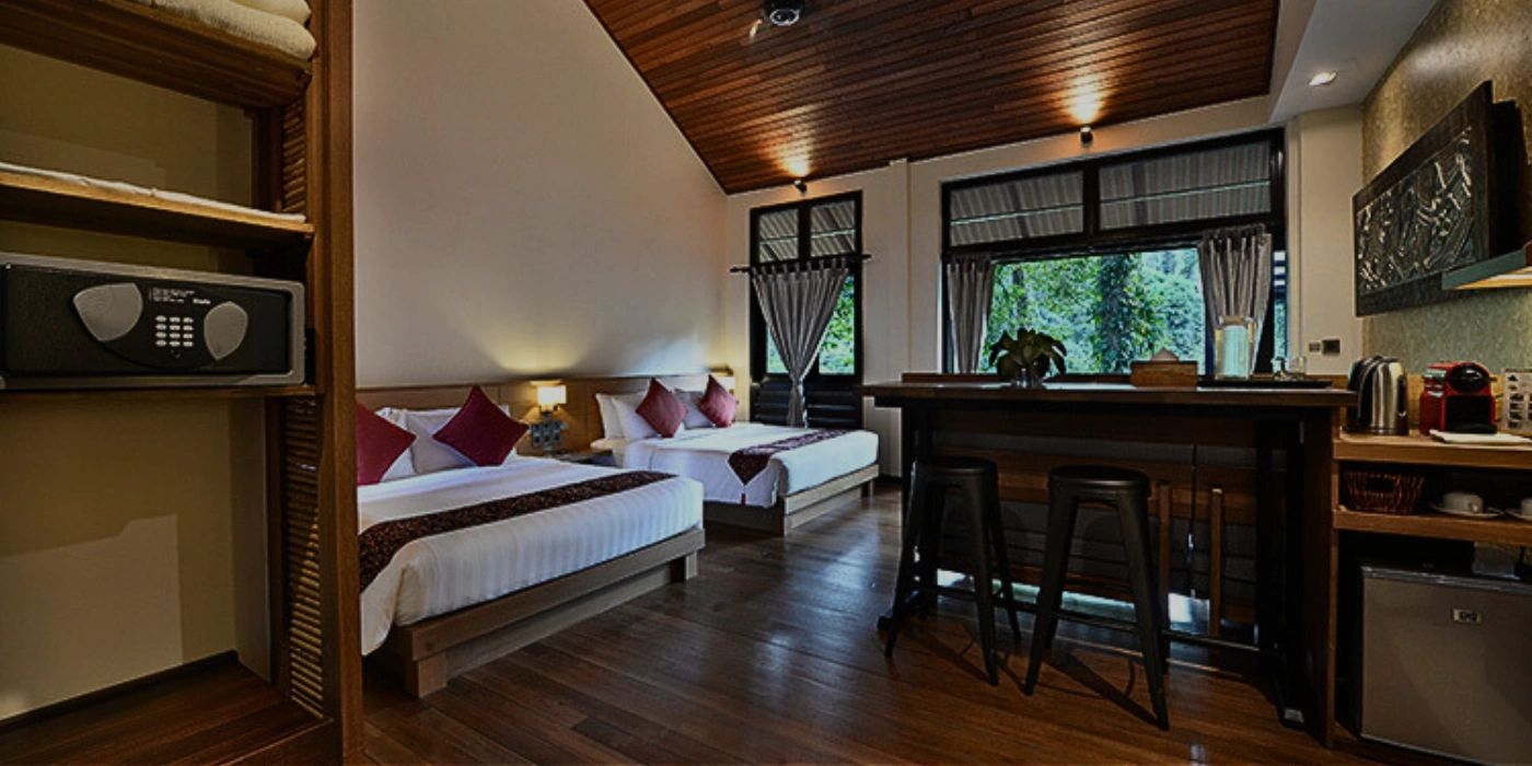 Elegant interior of a room at Borneo Rainforest Lodge featuring wooden accents, large windows, and jungle views